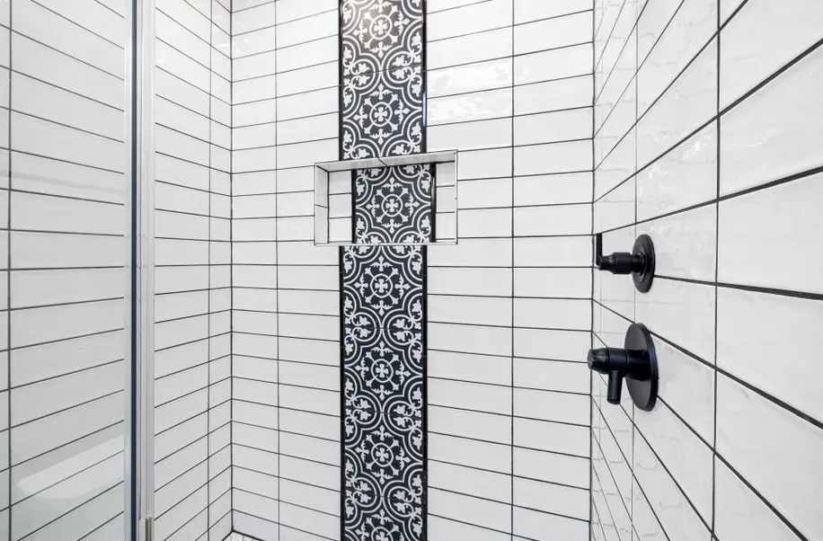 Tile installer working on a London bathroom floor